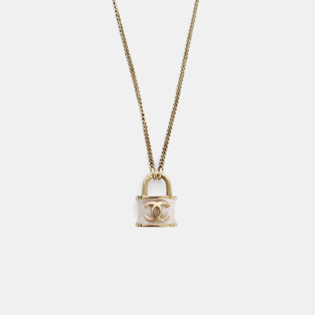 Chanel 2018 Gold Toned CC White Shimmer Lock Pendant Necklace Chanel 2018 Gold Toned CC White Shimmer Lock Pendant Necklace